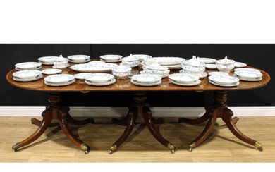 A Post-Regency mahogany triple-pillar dining table, each til...