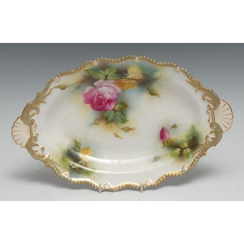 A Royal Worcester shaped oval dish, painted with pink and ye...