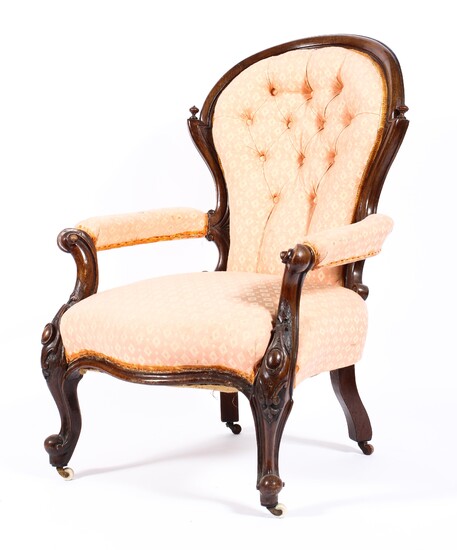 A Victorian mahogany framed button back upholstered armchair