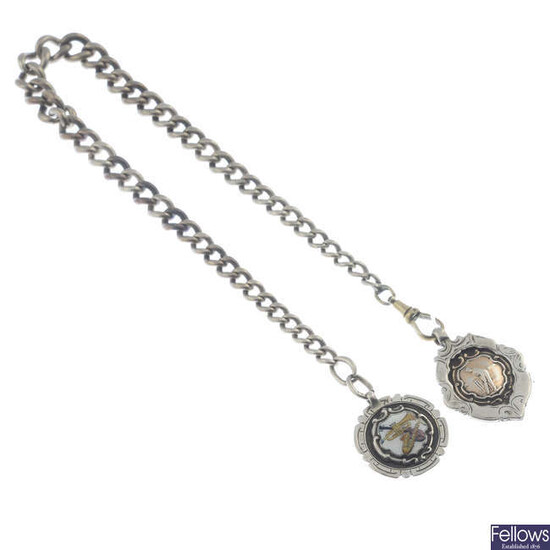 A Victorian silver albert chain and two fobs.