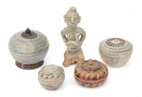 A collection of Sawankhalok earthenware consisting of four lidded boxes and a celadon figure of a sitting man with a bird, Thailand, 14th/15th century.