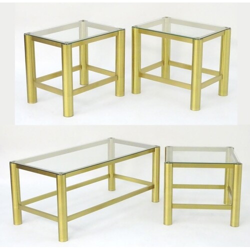 A collection of brass and glass coffee tables, comprising a ...
