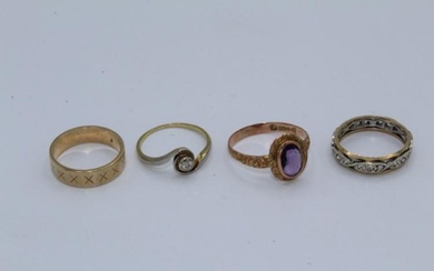 A collection of four precious metal rings. Featuring a diamond...