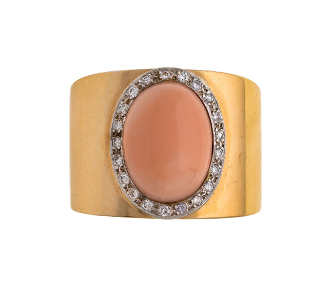 A coral and diamond ring, centring on an oval coral...
