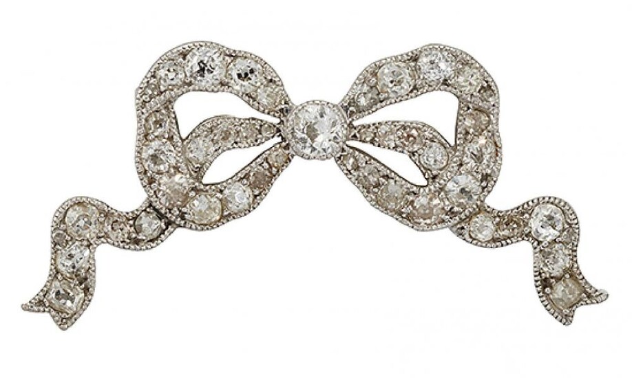 A diamond bow brooch, the openwork ribbon...