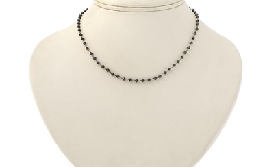 A diamond necklace set with numerous black faceted roundel-cut diamonds, mounted in...