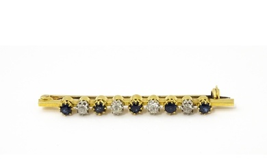 A gold bar brooch with platinum set diamonds, and blue stone...