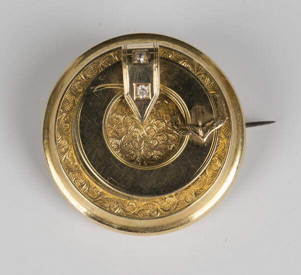 A gold circular buckle and strap brooch, mounted with two circular cut diamonds, otherwise with engr