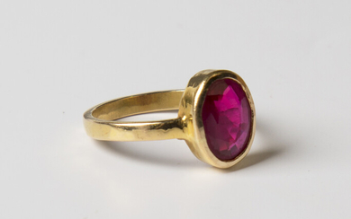 A gold ring, collet set with an oval cut synthetic ruby, probably Asian, unmarked, weight 3.8g, ring