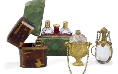 A group of four scent bottles, French and English, late 18th/early 19th century, comprising: a French set with two gold-mounted bottles and miniature funnel, in a shagreen case, the case - 6.5cm high; an English set, with one gilded blue glass...