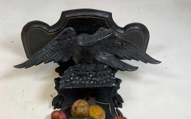 A painted and carved wall bracket set with an eagle...