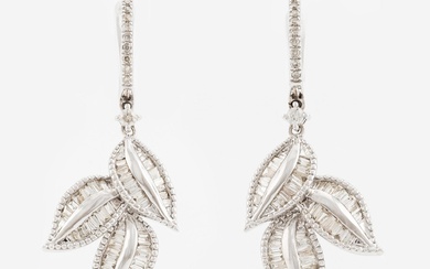 A pair of 14K gold earrings with baguette-cut diamonds