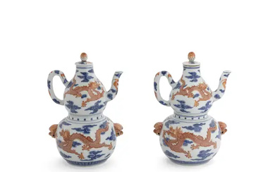 A pair of Chinese blue and white and iron-red double-gourd sectional wine...
