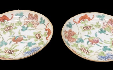 A pair of Chinese hand painted porcelain floral decorated saucers,...