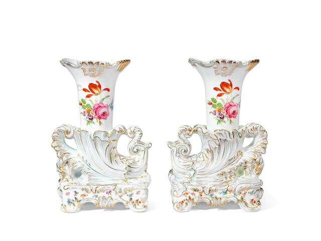 A pair of Continental porcelain rhyton shaped garniture vases