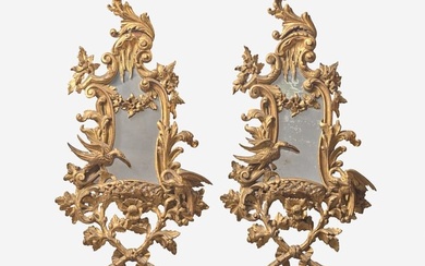 A pair of George III Rococo style giltwood mirrors, 20th century Of asymmetrical form, the