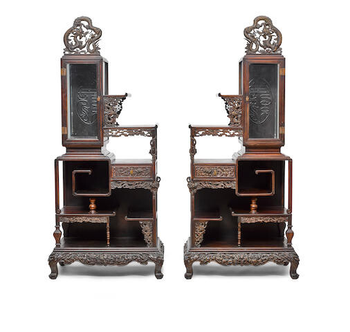 A pair of elaborate hardwood display cabinets