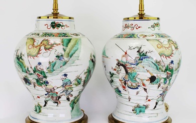 A pair of lamped famille verte vases with warrior scenes