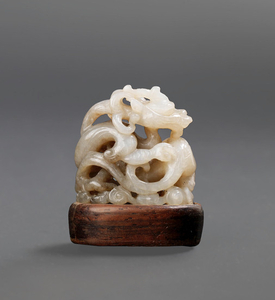 A rare white and brown jade reticulated 'dragon' finial