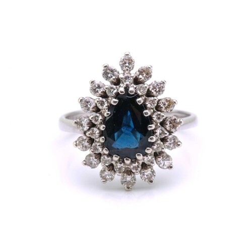 A sapphire and diamond entourage ring, featuring a pear-shap...