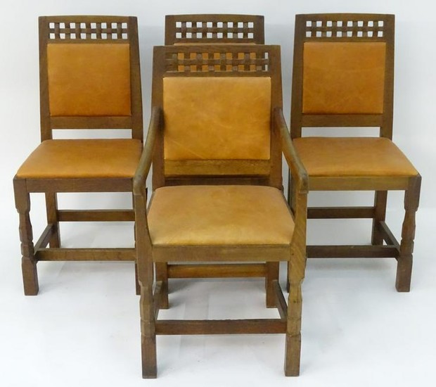 A set of four oak Arts and Crafts style dining chairs