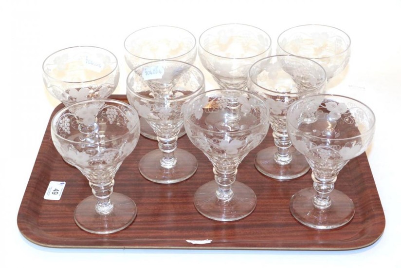 A set of nine 19th century stemmed wine glasses, etched...