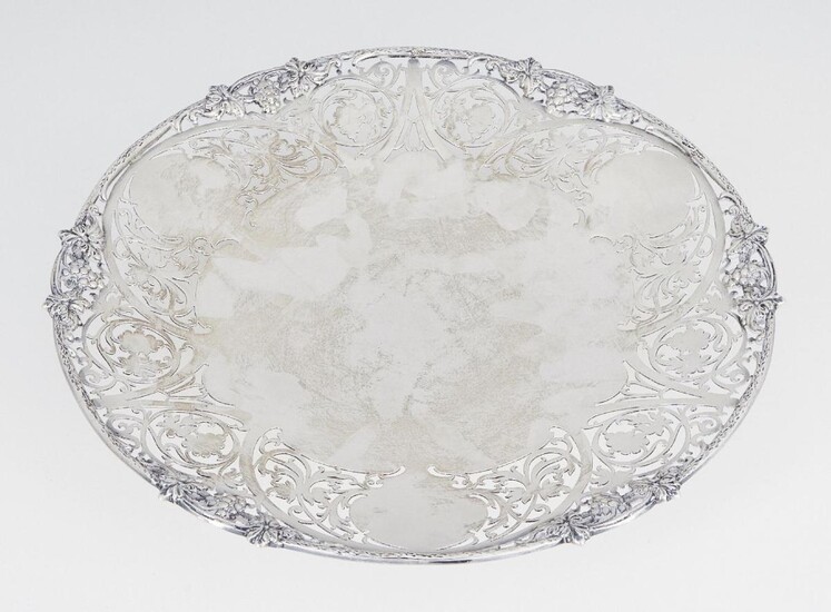 A shallow silver dish with pierced rim, Sheffield, c.1961, S J Rose & Son, of circular form, the scrolling foliate pierced sides to shaped rim with fruiting vine decoration, 26.5cm dia., approx. weight 19.8oz