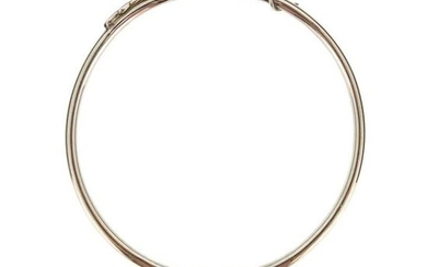 A silver bangle by Sarah Jones, set with...