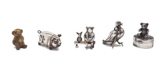 A silver model of Piglet and Winnie the Pooh seated on a bench, London, 1994, Sarah Jones, 3.8cm high, together with a silver model of a duck with a walking stick, London, 1994, Sarah Jones, 4cm high; a silver trinket box with a cast teddy bear to...