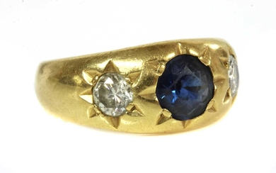A three stone sapphire and diamond gypsy ring