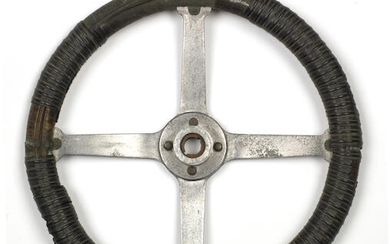 A vintage four-spoke steering wheel, patented 1906 and 1912