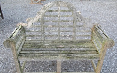 A weathered teak Lutyens style two seat garden bench, 136 cm...