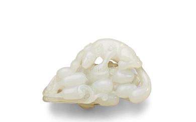 A white jade carving of a squirrel on grapes