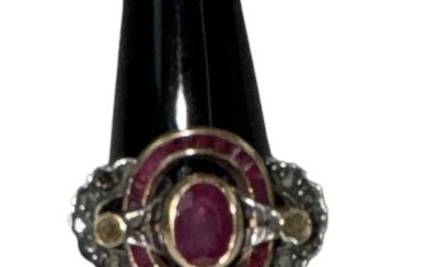 A yellow metal ruby and diamond set ring, the central...