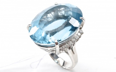 AN OVAL TOPAZ OF 66CTS AND DIAMOND COCKTAIL RING IN PLATINUM, SIZE M, 27.8GMS