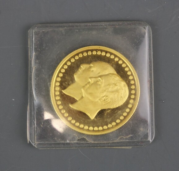 An Iranian bank of Melli 1976 gold commemorative coin, Dia. 2cm. Sealed in packet.