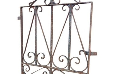 An antique wrought iron garden gate, with scrolled decoration...