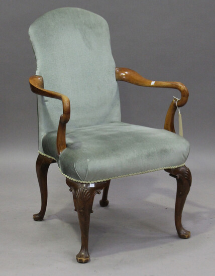 An early 20th century Queen Anne style walnut framed shepherd's crook elbow chair, raised on ca