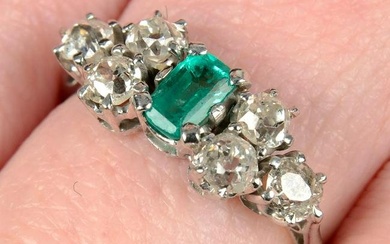 An early to mid 20th century gold emerald ring, with old-cut diamond trefoil shoulders.Emerald