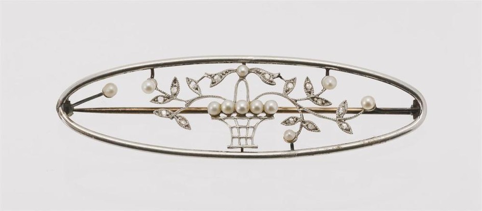 EDWARDIAN 14KT WHITE GOLD, DIAMOND AND SEED PEARL BROOCH Oval, filled with a basket of flowers. Length 2.5".