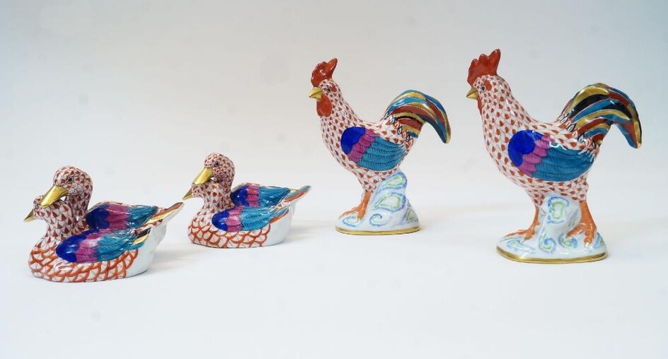 Four Herend porcelain animal figures, 20th century, comprising: a cockerel, with red fishnet design, having blue printed mark HEREND HUNGARY HANDPAINTED and impressed HEREND 5031 10, 13.8cm high; another similar cockerel, with blue printed marks...