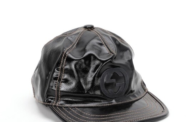 Gucci A cap of black patent leather with light brown stitching and...