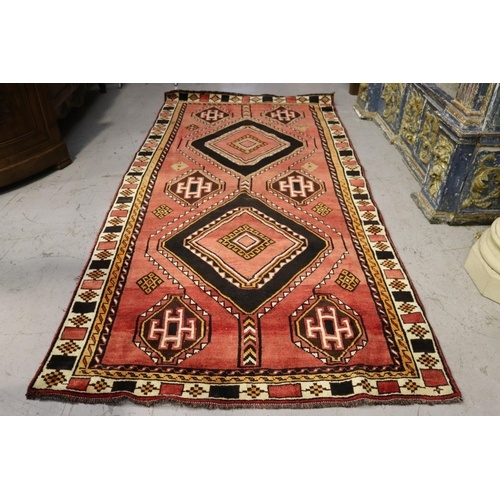 Hand knotted wool carpet, of red ground with two diamond gul...