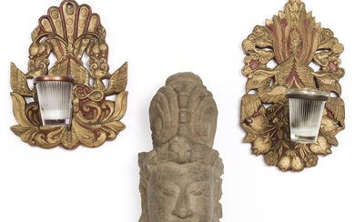 Java, two wooden wall brackets for oil lamps; herewith a stone Hindu head of a god.