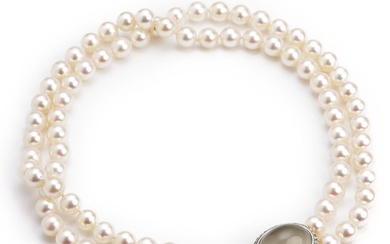 Ole Lynggaard: A double-strand pearl necklace with cultured pearls and a “Emeli” diamond clasp set with a cabochon moonstone and diamonds, mounted in 18k gold.