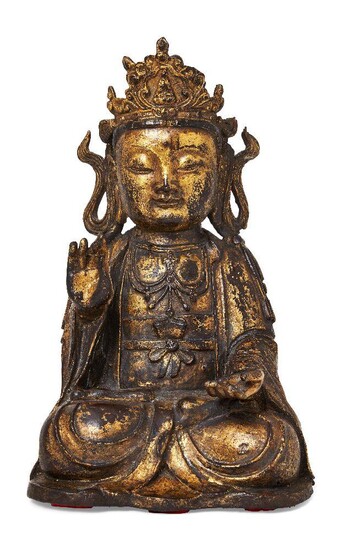 Property of a Gentleman (lots 36-85) A large Chinese gilt and lacquered bronze figure of Guanyin, Ming dynasty, 17th century, cast seated in dhyanasana with right hand raised and left hand resting upturned in her lap, wearing loose robes adorned...