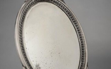 Silver oval table mirror on two scroll legs with ribboned