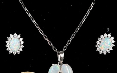 Star Lot : A sterling silver opal pendant & chain. Together ...