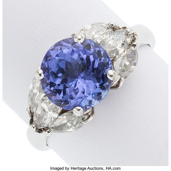 Tanzanite, Diamond, White Gold Ring The ring centers a...