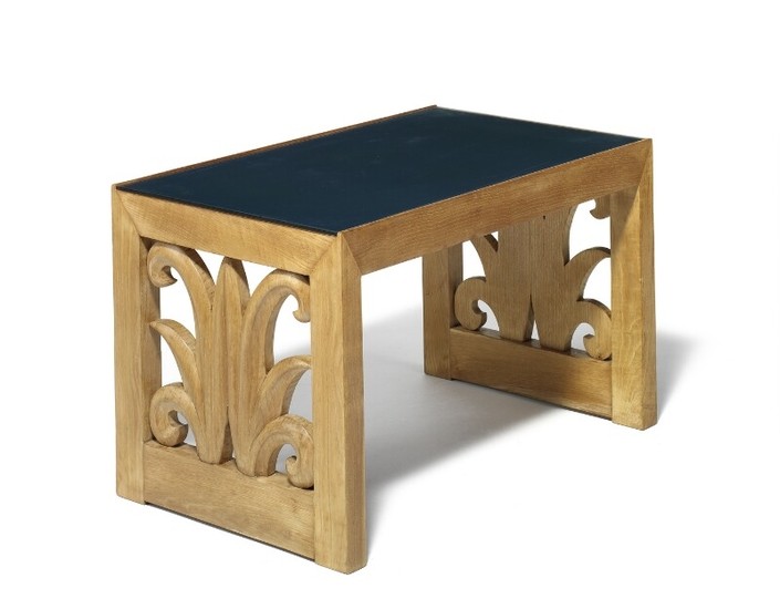 Tom Wolfenstein, attributed: Coffee table with solid oak frame, pierced sides carved with leaf motif. Top of glass under which blue vinyl.